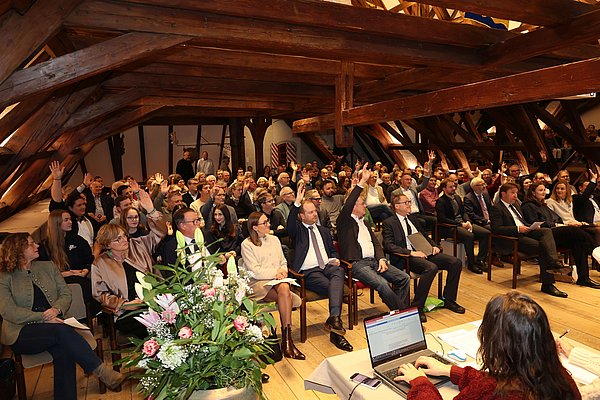 Blick in den Saal mit vielen Menschen.