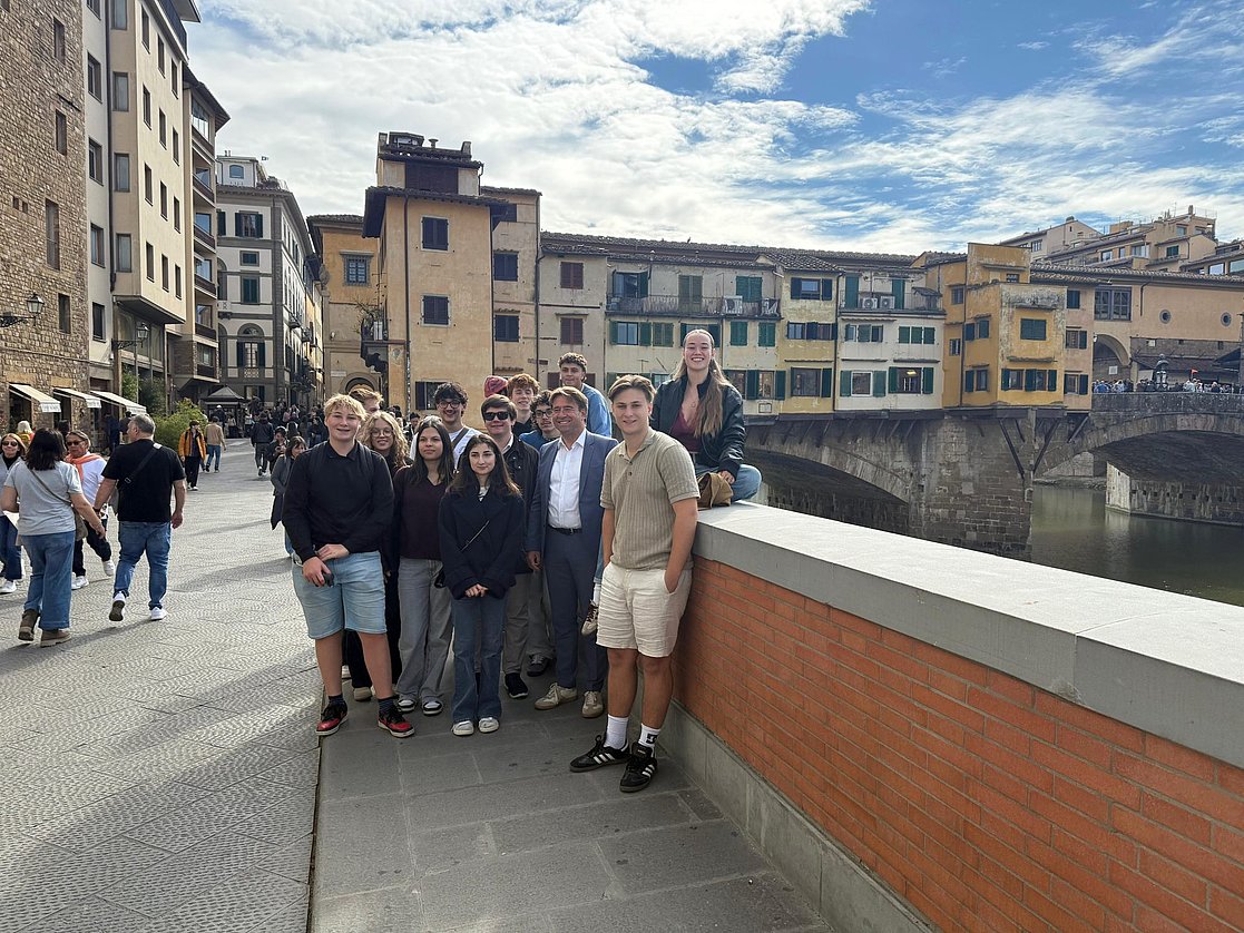 Gruppe junger Leute und OB Lang auf einer Brücke in Prato