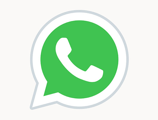 Ein grünes WhatsApp-Logo in Form einer Sprechblase mit einem weißen Telefonhörer innen. Der Hintergrund ist schwarz.