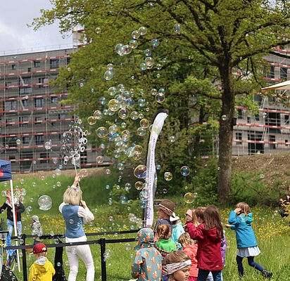 Seifenblasen fliegen, Kinder jagen ihnen nach